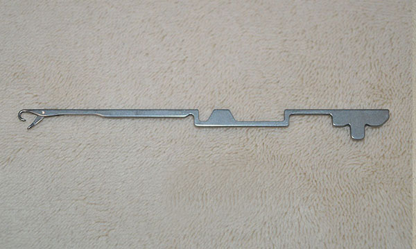 This item is a industrial circular knitting machine needle used in textile manufacturing.