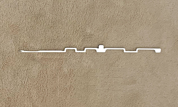 This item is a steel industrial knitting machine needle, often used in circular hosiery or textile machines.