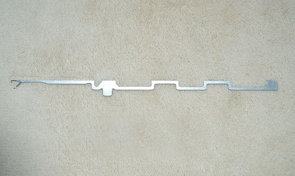 This item is a latch needle used in industrial knitting machines, specifically for circular knitting hosiery or apparel production.