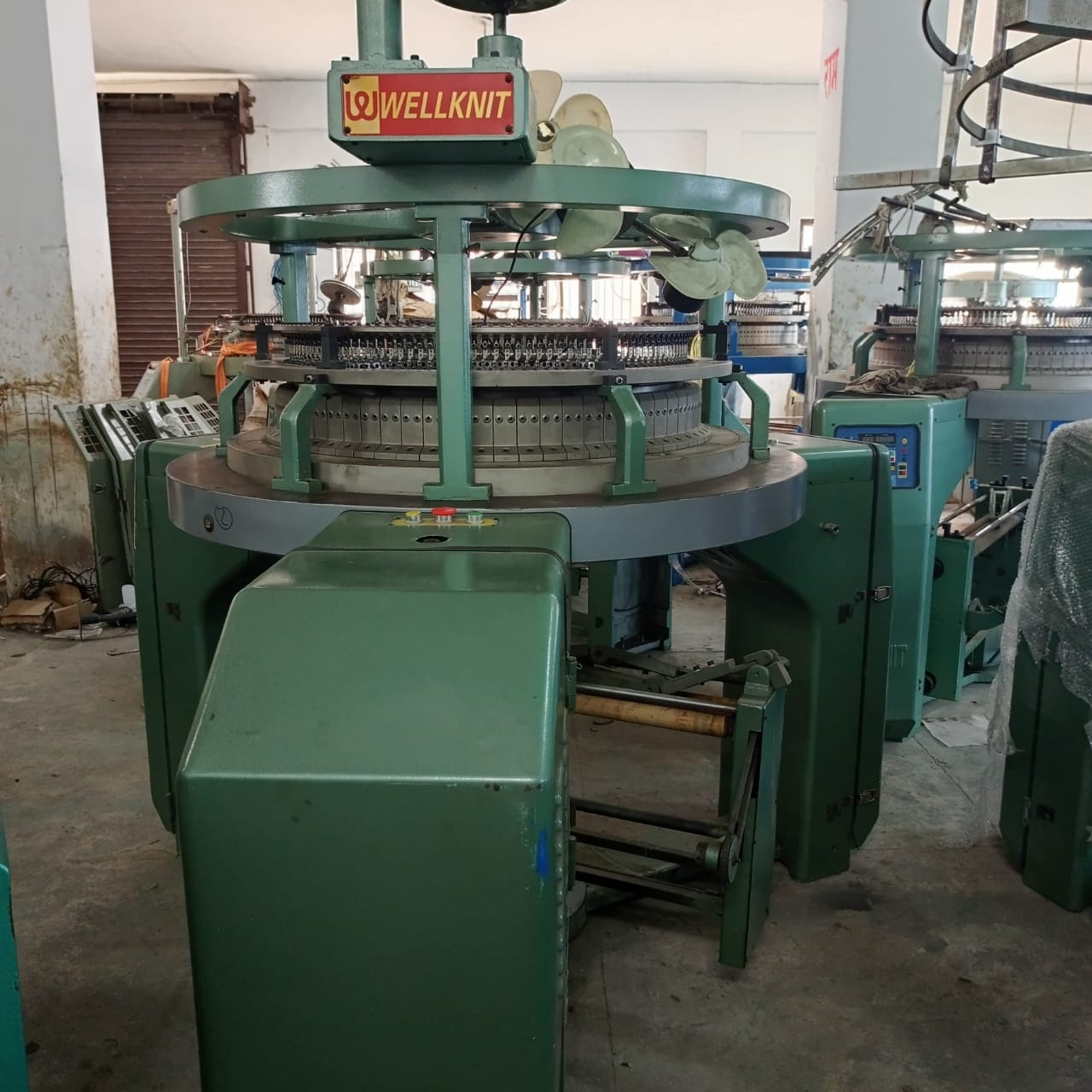 This image shows a Wellknit industrial circular knitting machine.